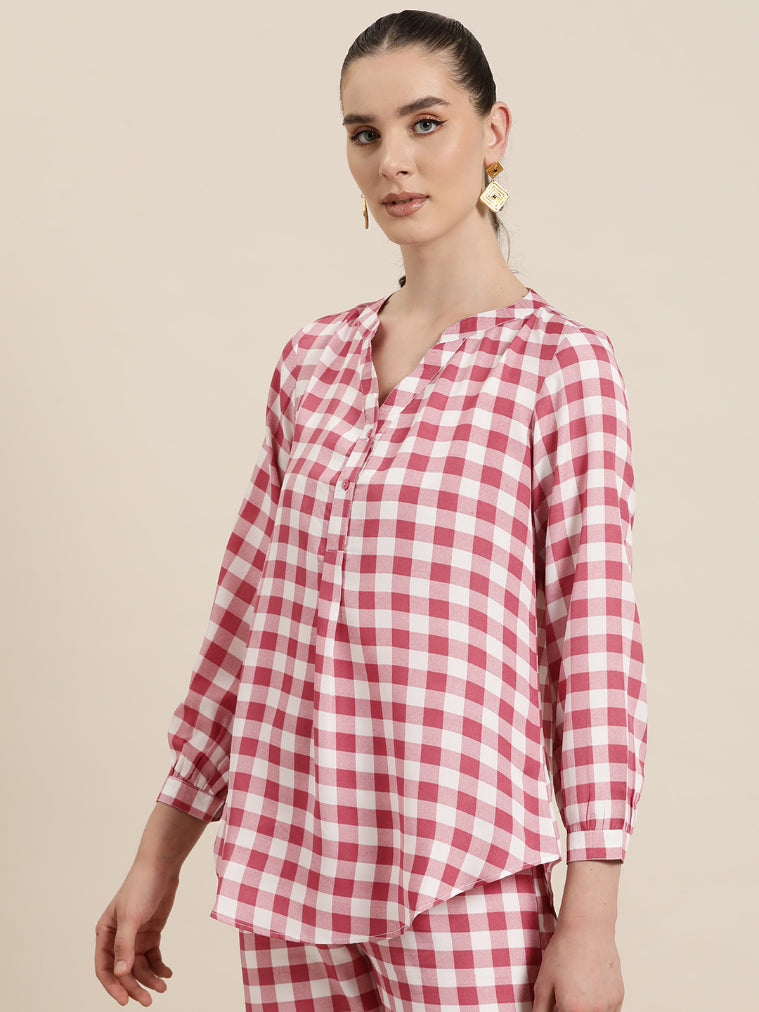 Pink and White plaid half placket shirt with full cuff sleeves.