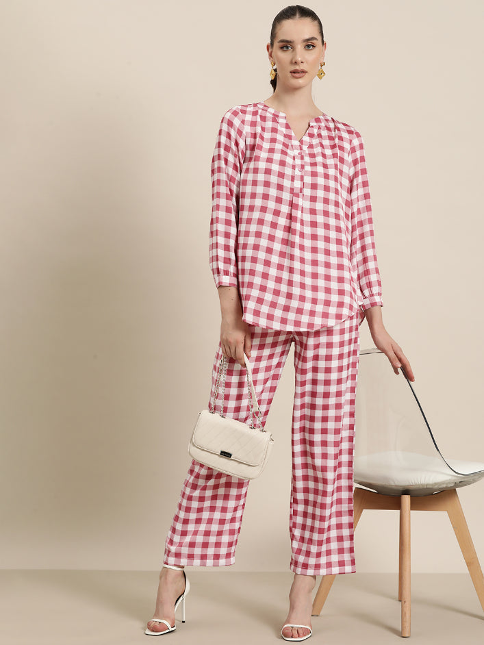 Pink and White plaid half placket shirt with full cuff sleeves.
