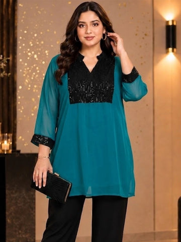 Teal green tunic with sequence yoke