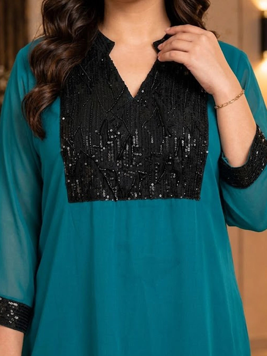 Teal green tunic with sequence yoke