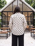 black polka satin shirt — close-up detail