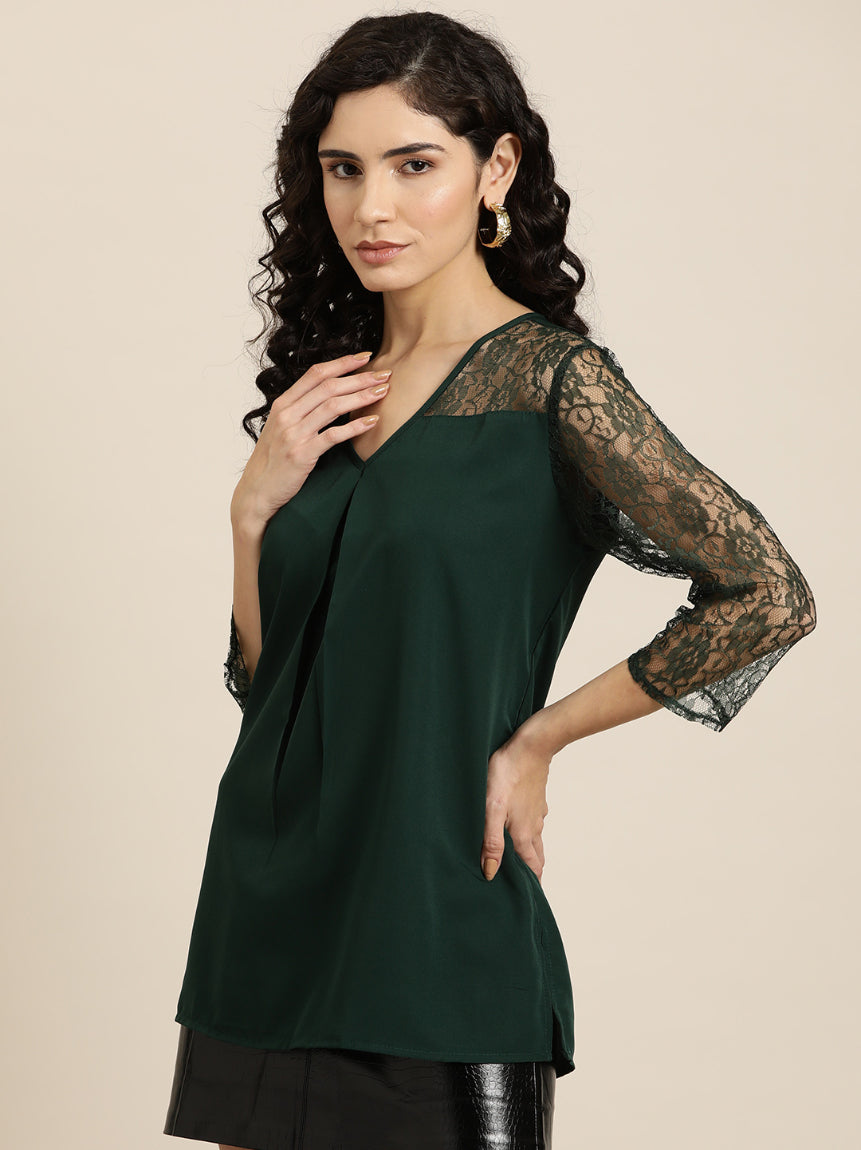 Emerald green crepe top with floral net sleeves and yoke