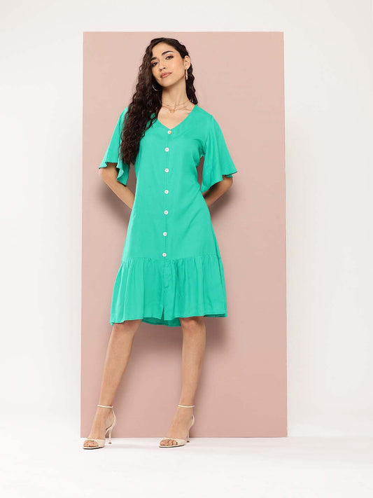 Solid rayon A-line style with a V-neckline and ruffle details. It features decorative show buttons