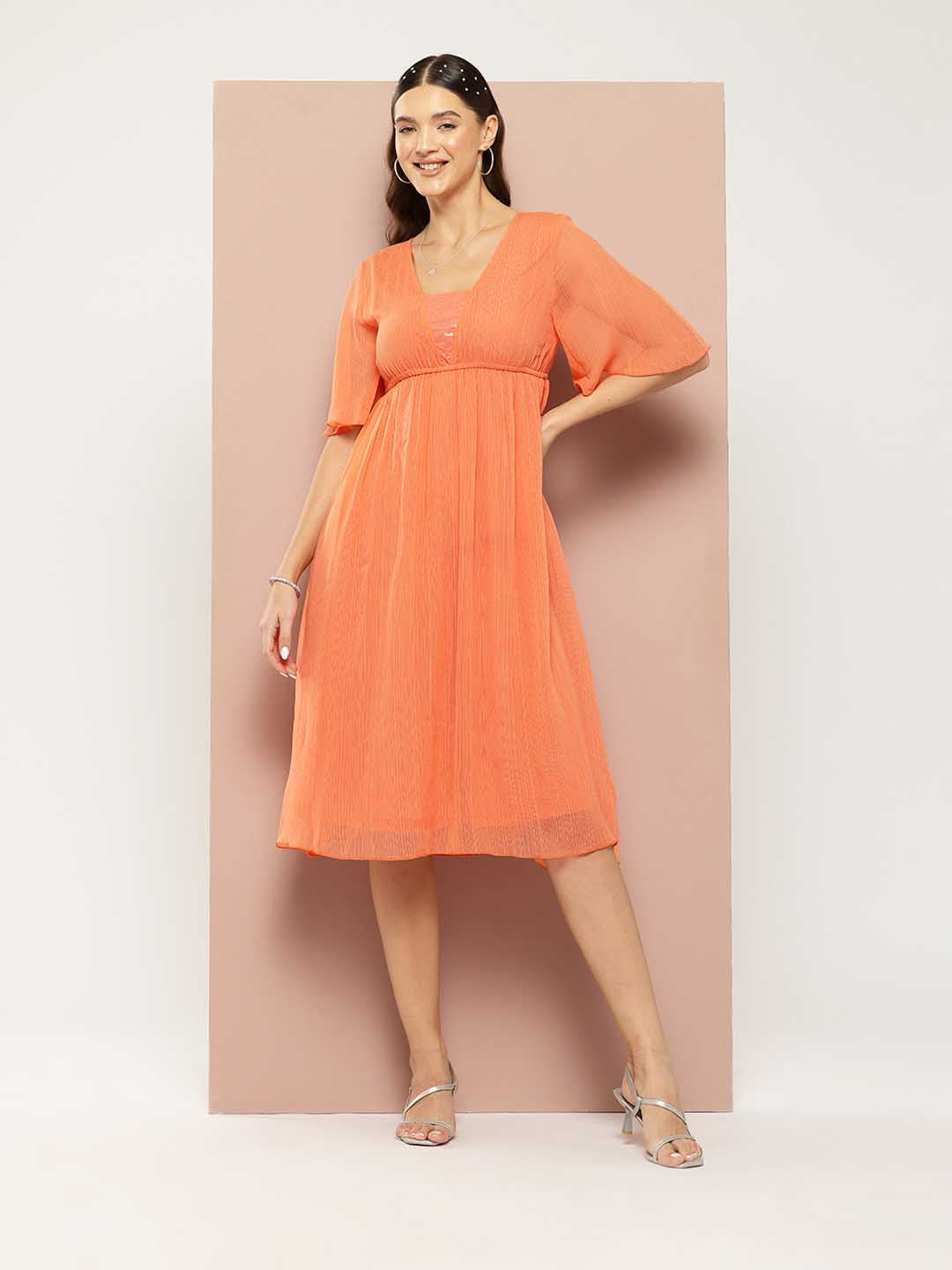 Orange georgette fit and flared party dress with sequins embelishment