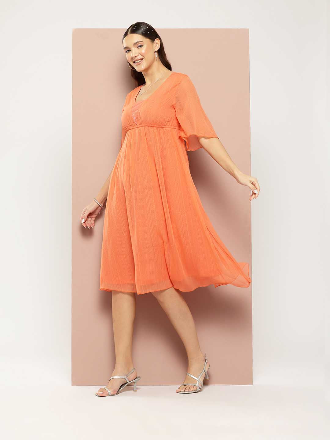 Orange georgette fit and flared party dress with sequins embelishment