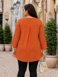 orange crepe top — close-up detail