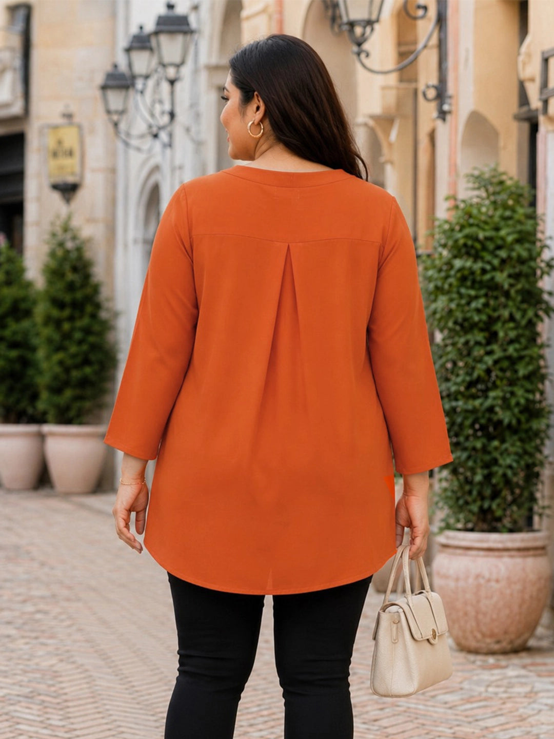 orange crepe top — close-up detail