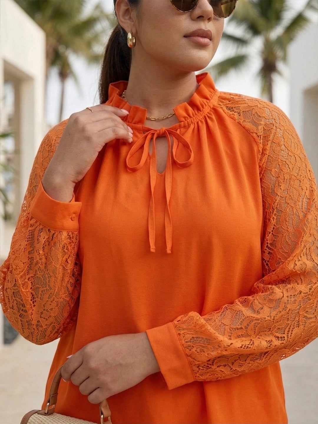 Orange tie-up neck top with sheer lace sleeves