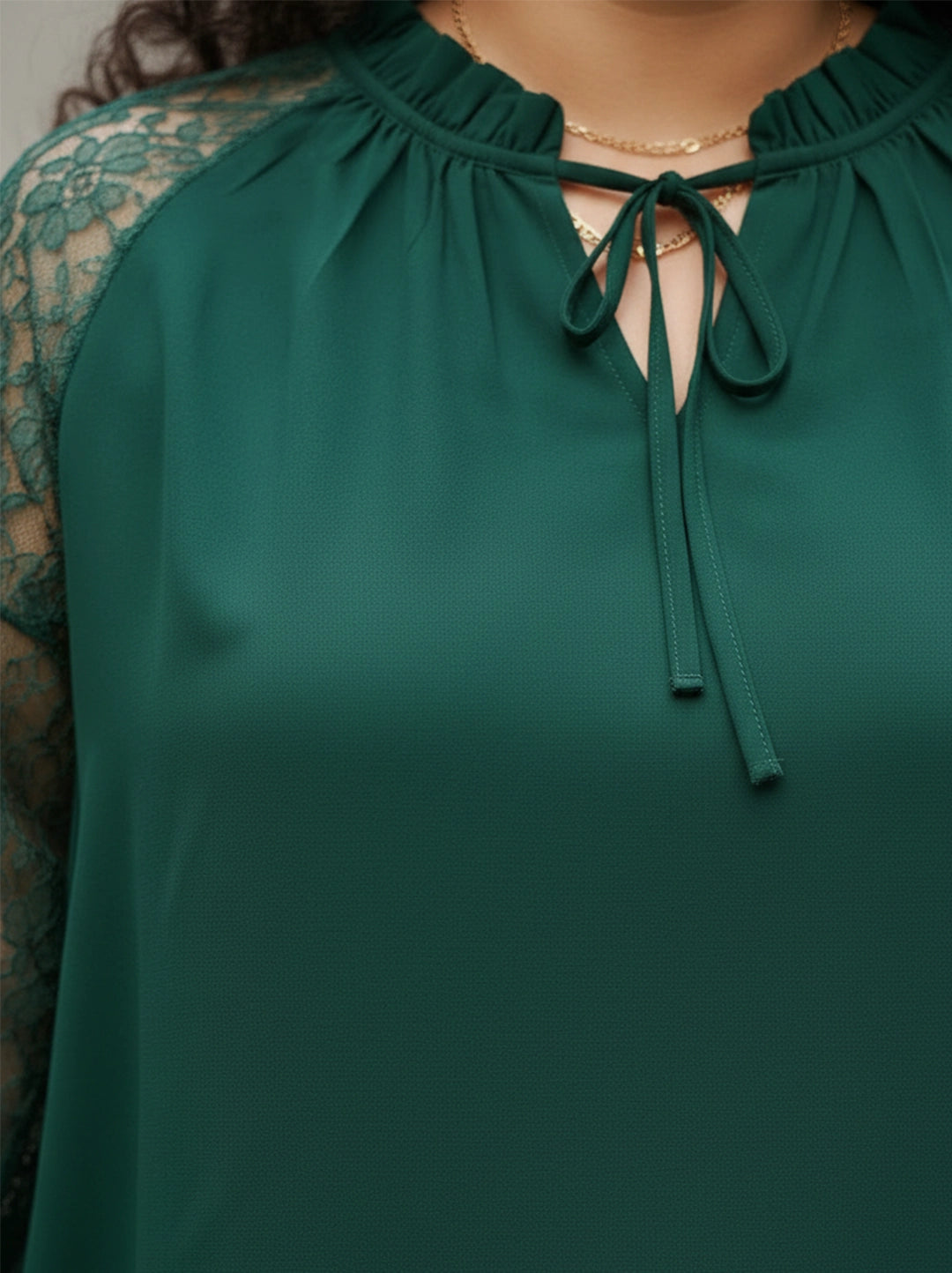 Green tie-up neck top with sheer lace sleeves