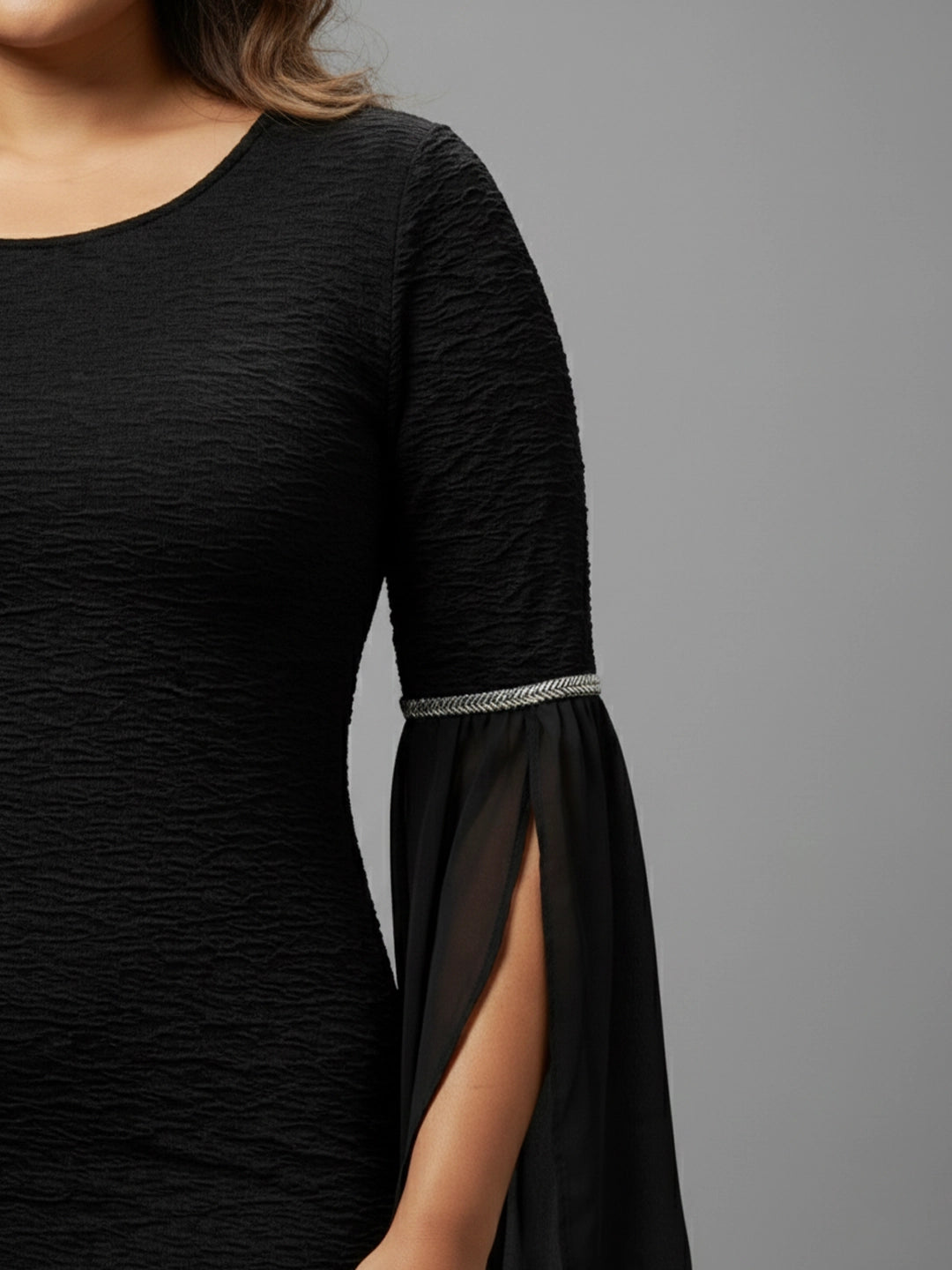 Black bodycon dress with embellished bell sleeves