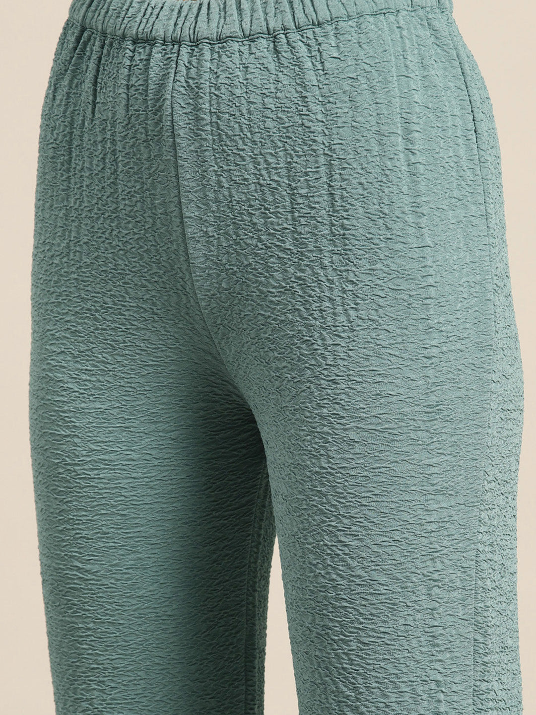 Sea green full slevees hoodie with a gold zipper and pant set.